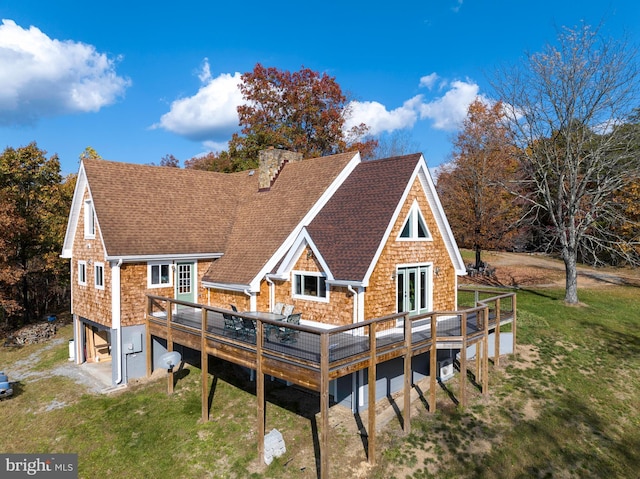 back of house featuring a wooden deck and french doors