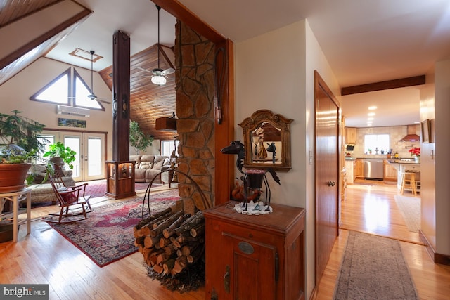 living room with ceiling fan, french doors, high vaulted ceiling, and light hardwood / wood-style floors