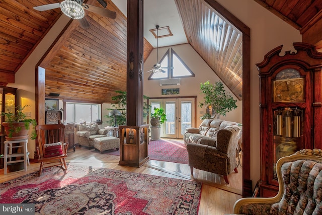 living room featuring ceiling fan, light hardwood / wood-style floors, high vaulted ceiling, and french doors