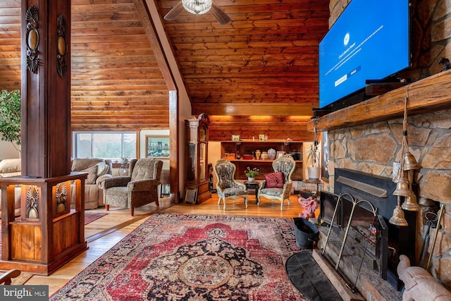 living room with ceiling fan, light hardwood / wood-style flooring, high vaulted ceiling, wooden ceiling, and a stone fireplace