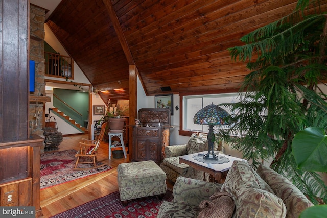 living room with hardwood / wood-style floors, vaulted ceiling with beams, and wood ceiling