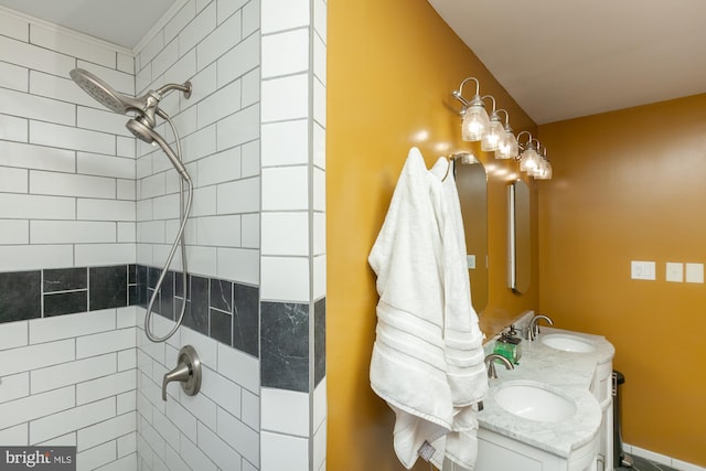 bathroom with vanity and a tile shower