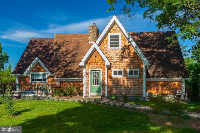 tudor home featuring a front lawn