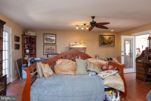 bedroom featuring hardwood / wood-style flooring and ceiling fan