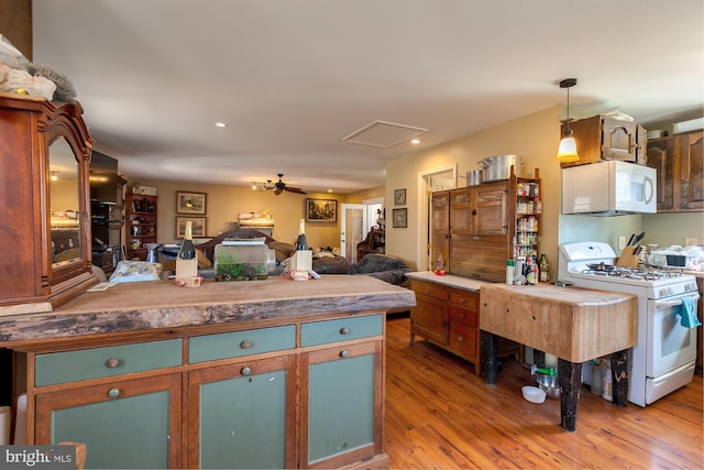 kitchen with hardwood / wood-style floors, decorative light fixtures, ceiling fan, and white appliances