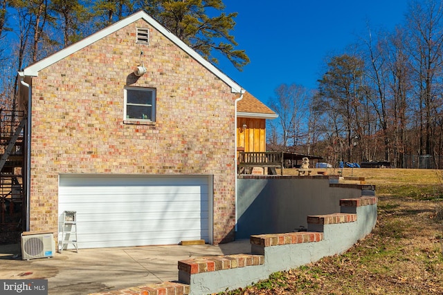 view of side of property featuring ac unit and a garage