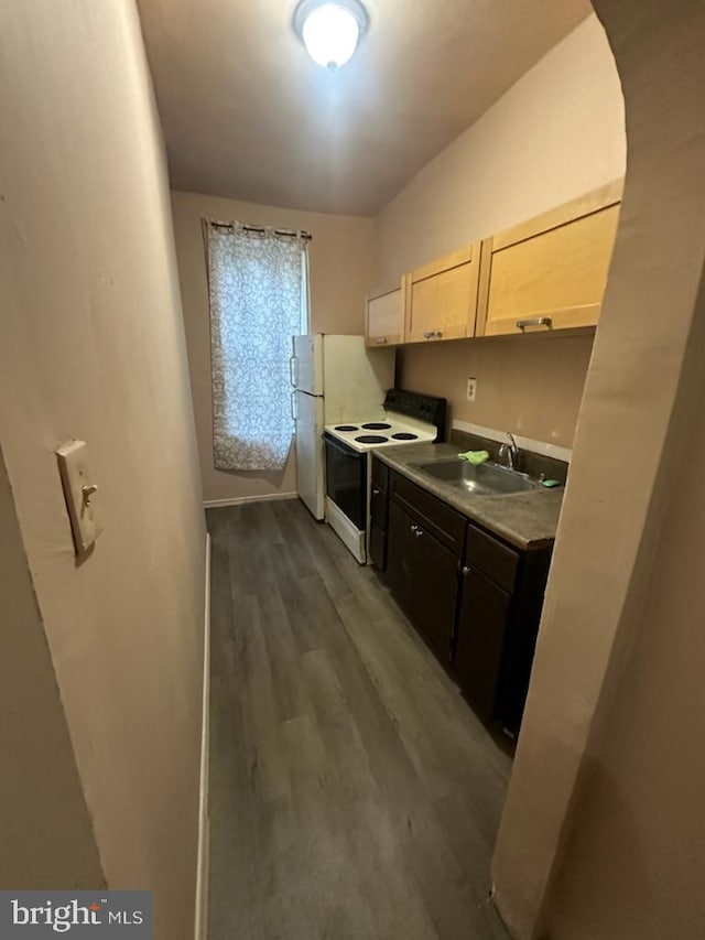 kitchen featuring dark hardwood / wood-style flooring, white range with electric stovetop, sink, and light brown cabinetry