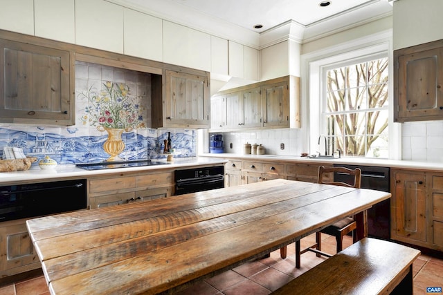 kitchen featuring black appliances, butcher block counters, and backsplash