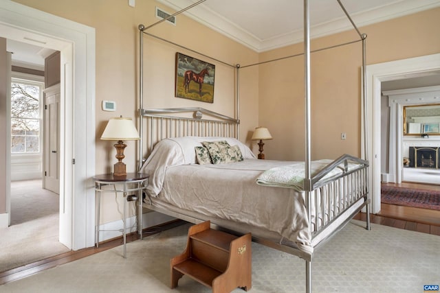 bedroom featuring crown molding, a closet, and hardwood / wood-style flooring