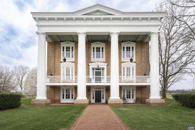 greek revival house with french doors and a front lawn