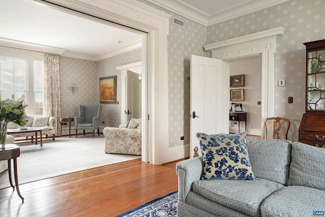 living room featuring hardwood / wood-style floors and crown molding