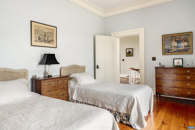 bedroom featuring hardwood / wood-style flooring and ornamental molding