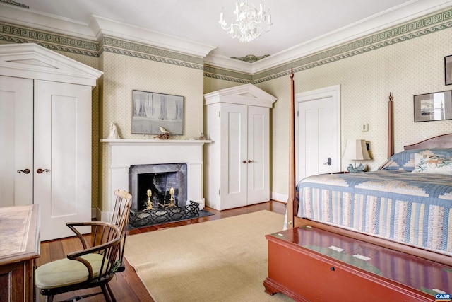 bedroom with a chandelier, hardwood / wood-style flooring, and crown molding