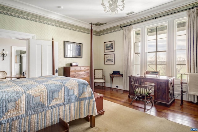 bedroom with dark hardwood / wood-style flooring, crown molding, and a notable chandelier