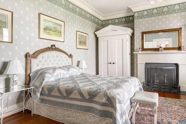 bedroom with crown molding and dark hardwood / wood-style flooring