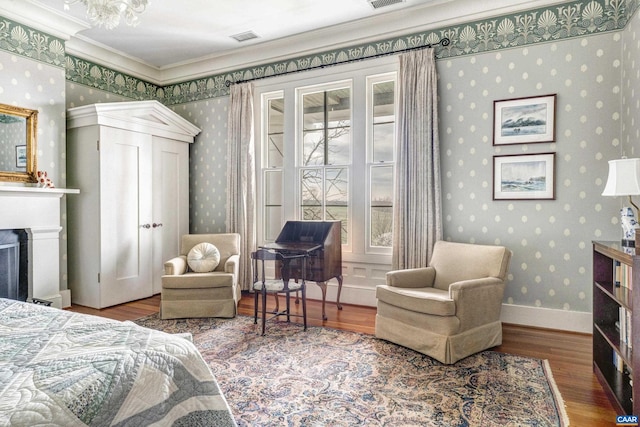 bedroom featuring ornamental molding and hardwood / wood-style flooring