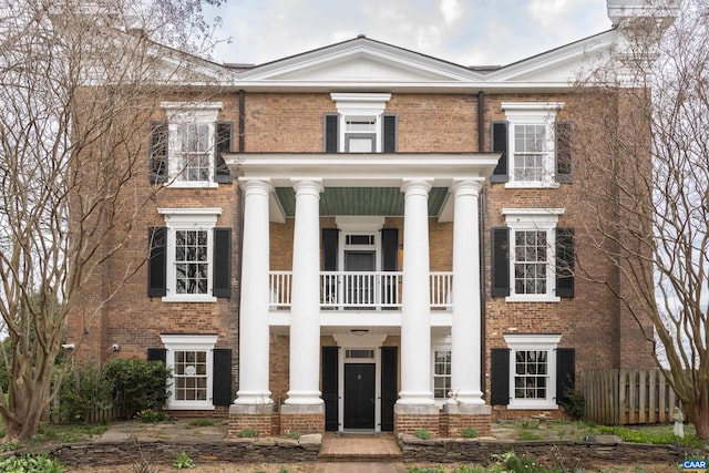 greek revival inspired property with a balcony