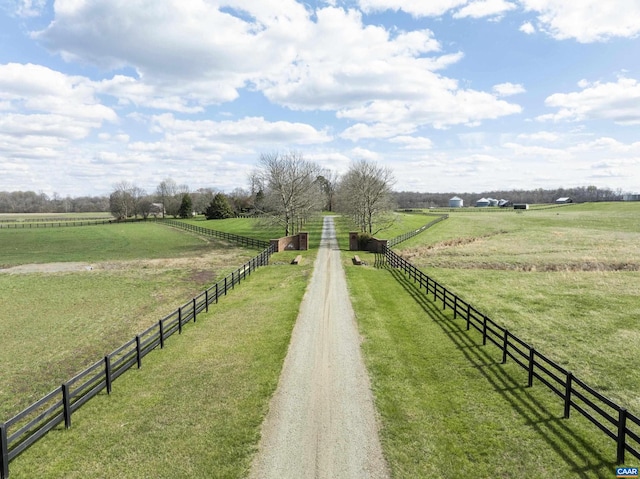 view of community with a yard and a rural view