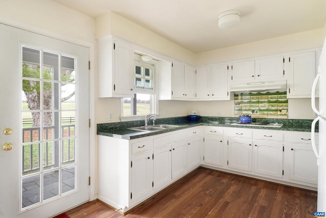 kitchen with white cabinets, dark hardwood / wood-style floors, white gas stovetop, and sink