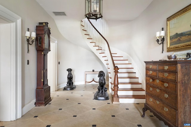 stairway with tile patterned floors