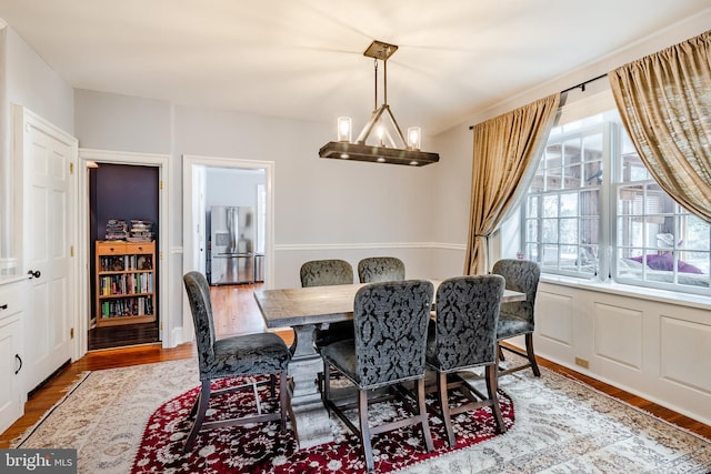 dining room featuring a notable chandelier and light hardwood / wood-style flooring