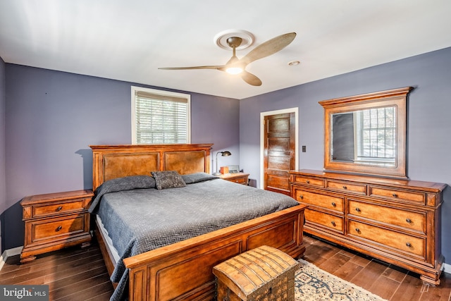 bedroom with ceiling fan and dark hardwood / wood-style floors