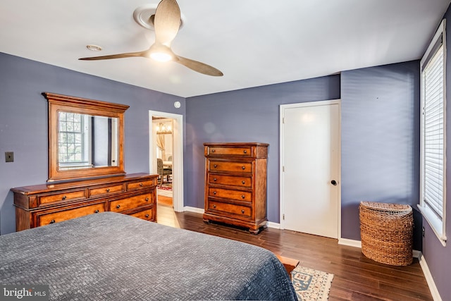 bedroom with ceiling fan and dark hardwood / wood-style floors