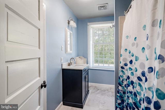 bathroom featuring tile floors and oversized vanity