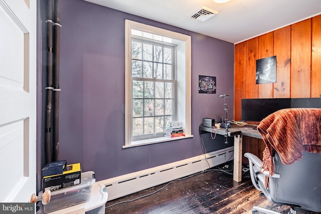 office area featuring baseboard heating, a wealth of natural light, and dark hardwood / wood-style flooring