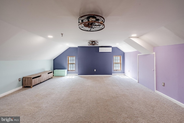 bonus room featuring lofted ceiling, a wall unit AC, and light colored carpet