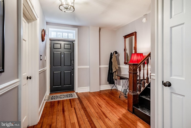 foyer with an inviting chandelier and light hardwood / wood-style flooring