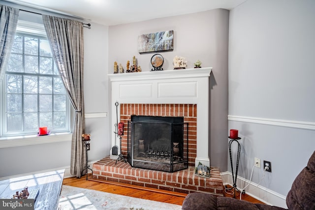 interior space featuring hardwood / wood-style floors and a brick fireplace