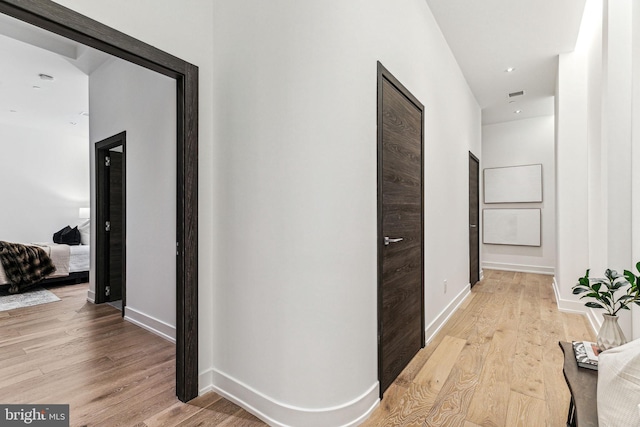 corridor with light wood-type flooring