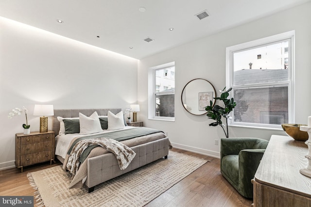 bedroom featuring hardwood / wood-style flooring and multiple windows