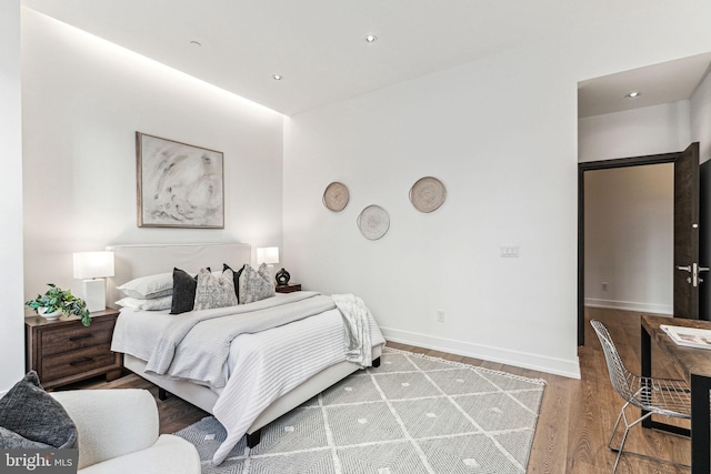 bedroom with hardwood / wood-style floors