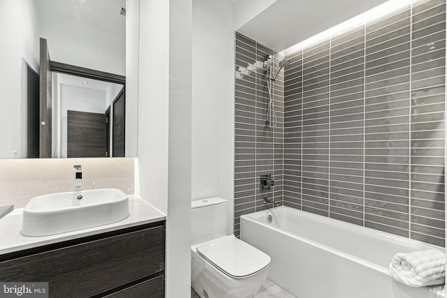 full bathroom with vanity, toilet, and tiled shower / bath