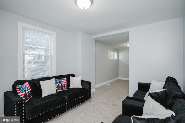 living room with carpet flooring and a healthy amount of sunlight