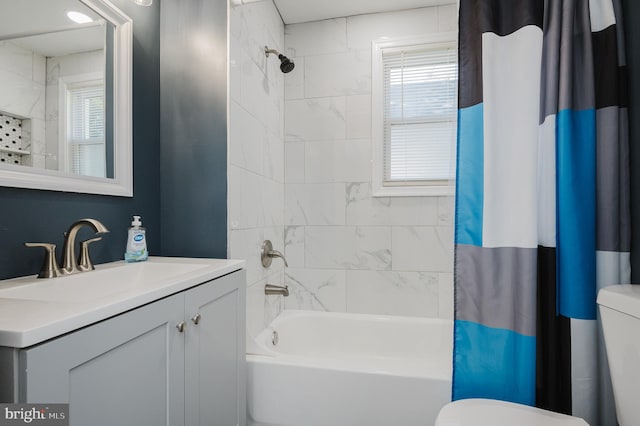 full bathroom featuring vanity, toilet, a healthy amount of sunlight, and shower / bath combination with curtain