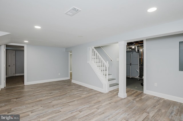 basement with light hardwood / wood-style flooring