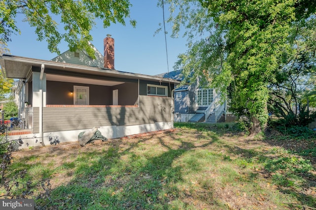 view of property exterior featuring a lawn