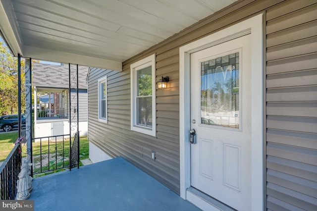 view of exterior entry featuring covered porch