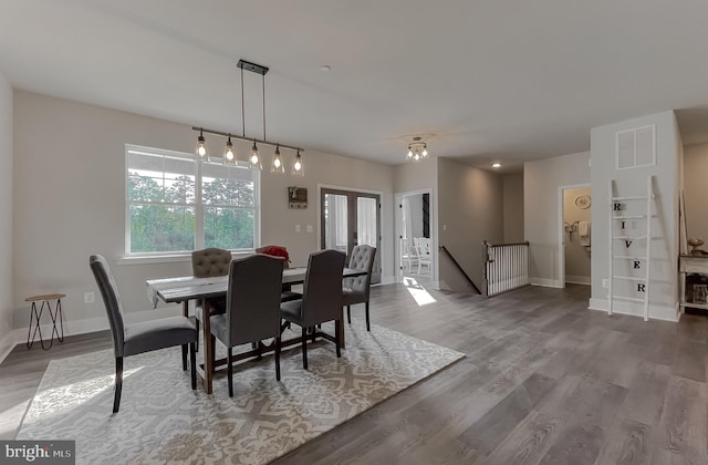 dining space featuring hardwood / wood-style flooring and french doors