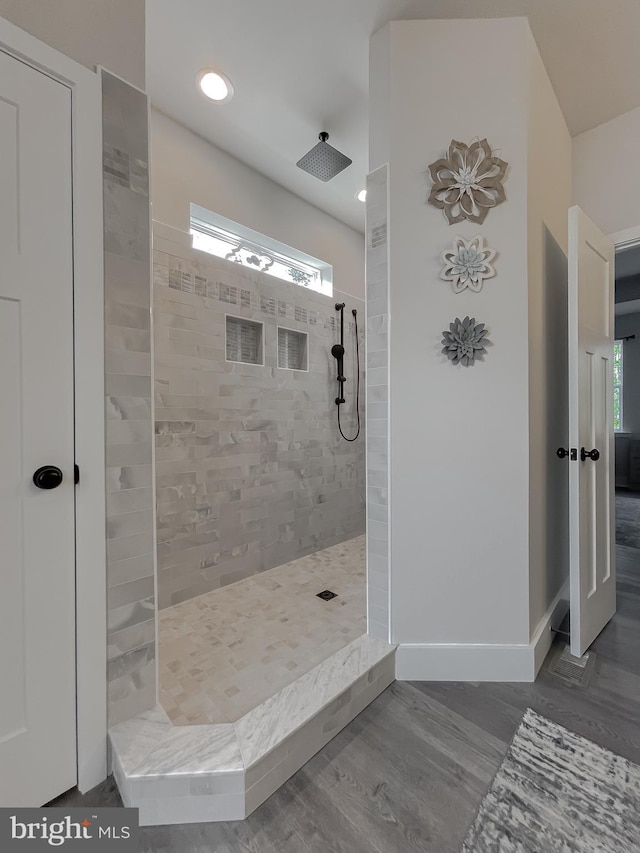 bathroom with a tile shower