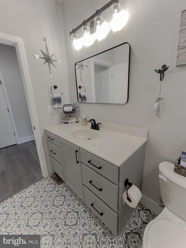 bathroom featuring vanity and toilet