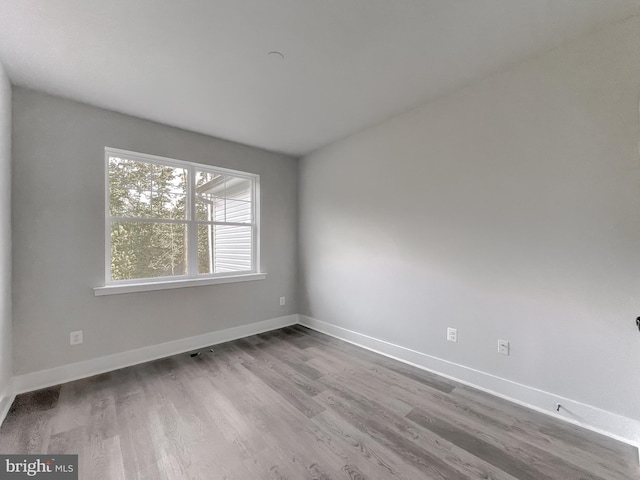 empty room with wood-type flooring