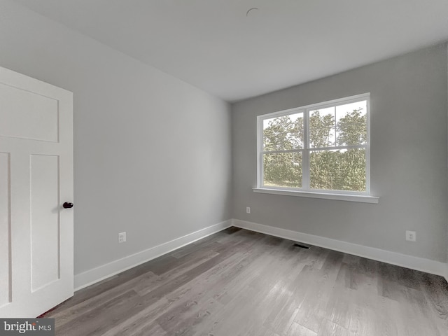 spare room featuring hardwood / wood-style flooring