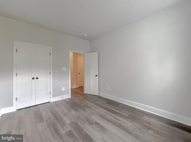 unfurnished bedroom featuring a closet and light hardwood / wood-style flooring