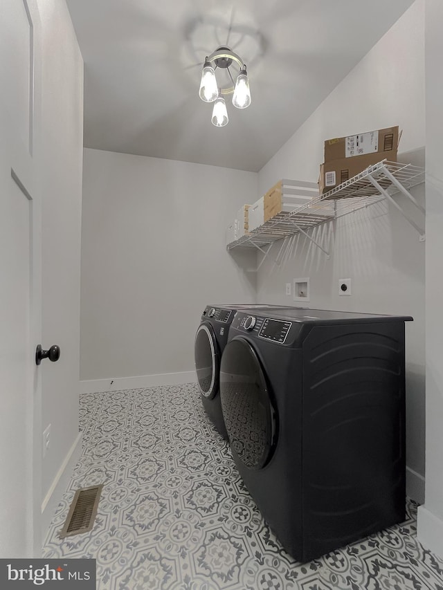 washroom with light tile patterned flooring and washing machine and clothes dryer