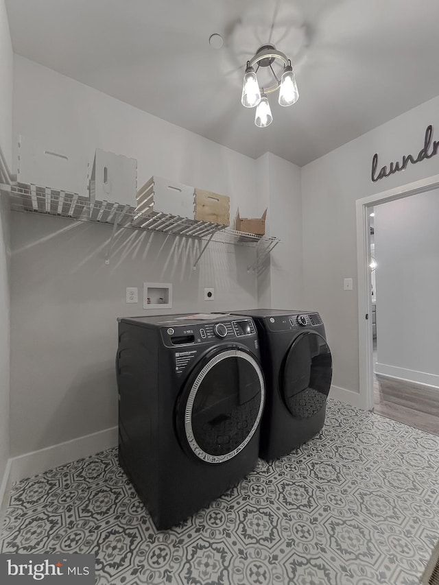 laundry room featuring light tile patterned floors and washer and clothes dryer