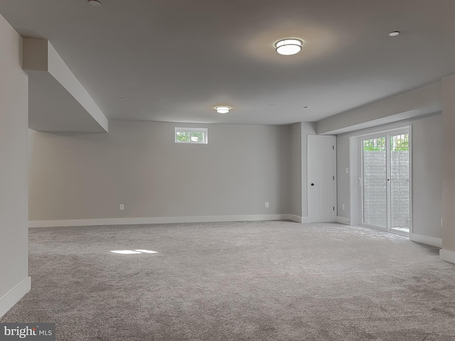 basement featuring light carpet